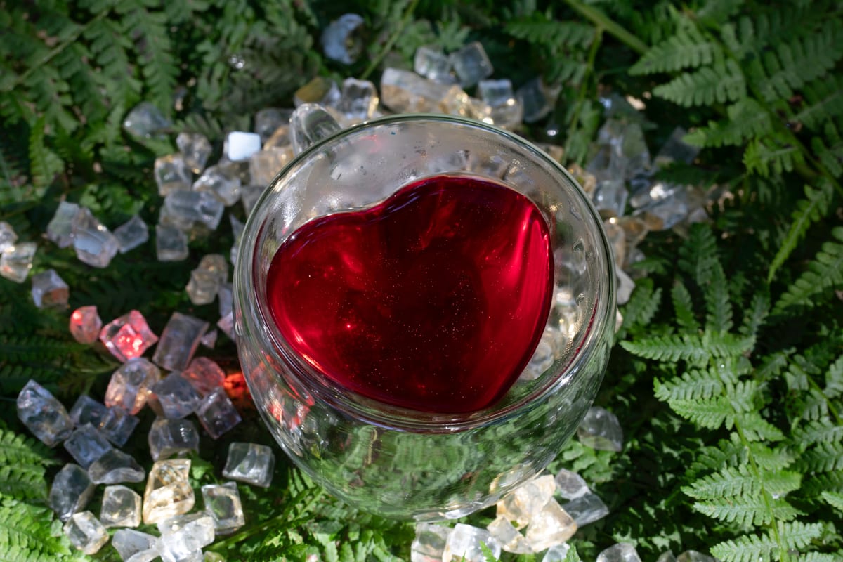 Glass mug of glittering tea in golden outdoor light